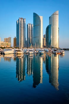 Busan marina with yachts, Marina city skyscrapers with reflection on sunset, South Korea