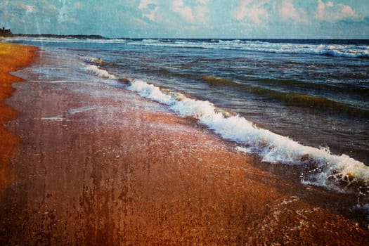 Vintage retro hipster style travel image of wave surging on sand on beach with grunge texture overlaid