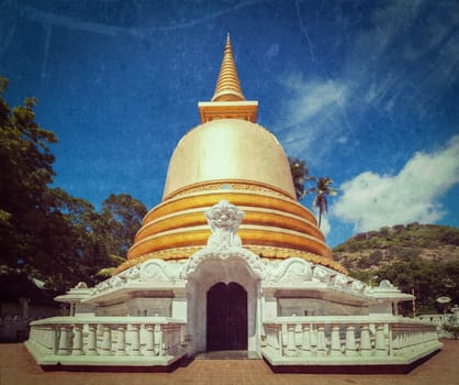 Vintage retro hipster style travel image of buddhist dagoba (stupa) close up with grunge texture overlaidin Golden Temple, Dambulla, Sri Lanka
