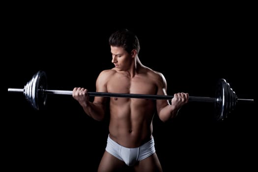 Portrait of handsome sportsman lifting weights, close-up