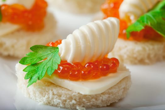 Delicious sandwiches with caviar and butter, close-up