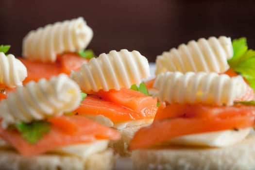 Appetizing sandwiches with salmon and butter, close-up