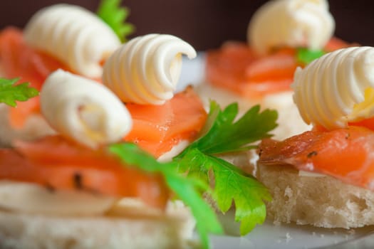 Tasty sandwiches with smoked trout and butter, close-up