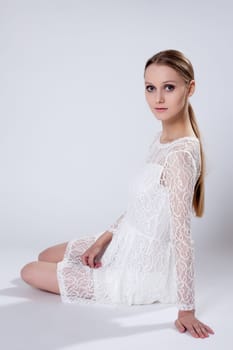 Romantic young girl posing in elegant dress, close-up