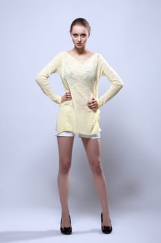 Beautiful young model demonstrates casual clothes, in studio