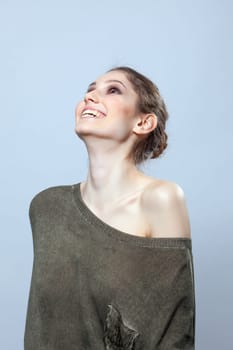Beautiful woman laughing in studio, close-up
