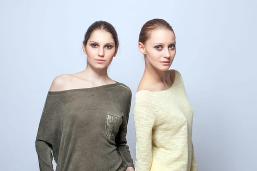 Image of two charming models posing in casual clothes