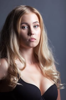 Portrait of pretty young woman with curly hair, close-up