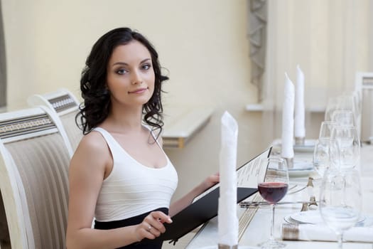 Portrait of lovely woman making order in restaurant