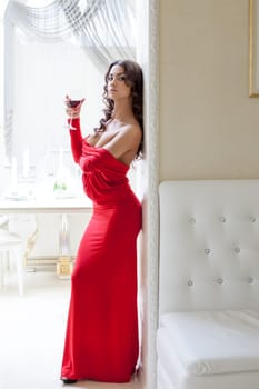 Image of seductive brunette posing in long red dress