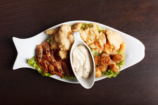 Image of hearty fish snacks served with sauce, close-up