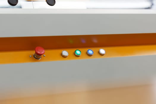 Image of glowing buttons on working loom, close-up