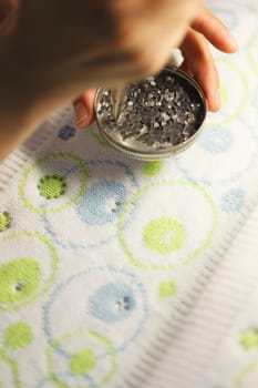 Image of gluing sequins to tissue, close-up