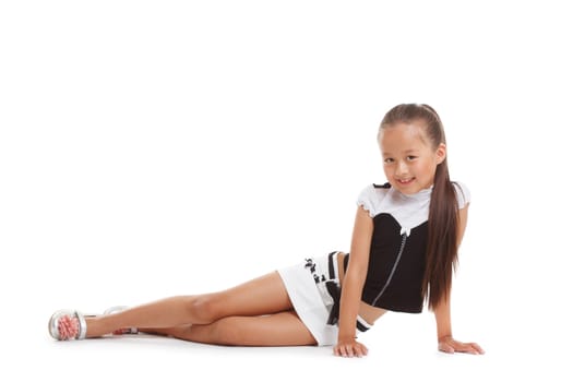 Image of smiling little brunette posing in studio, isolated on white