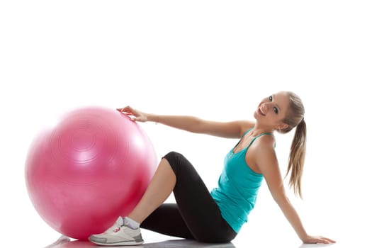 Image of cheerful young athlete posing with ball, isolated on white