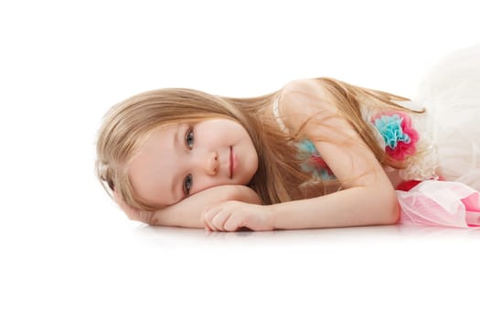 Portrait of smiling adorable girl lying in studio, close-up
