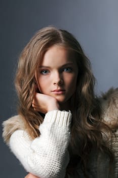Portrait of young charming girl posing in studio, close-up