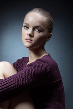 Portrait of beautiful teenage girl posing in studio, close-up