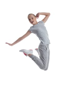 Sporty girl jumping in studio isolated on white background