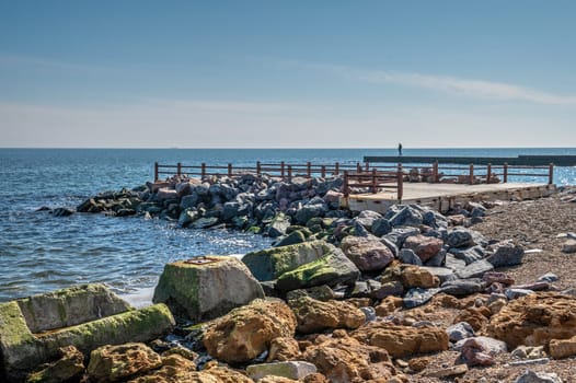 Shell rock boulders on the seashore on the Wild Beach in Odessa, Ukraine, on a sunny spring day