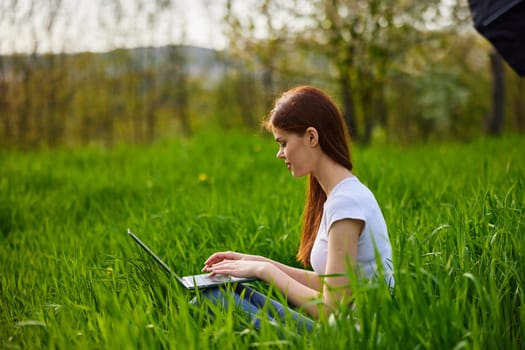 student with a laptop in the park working. High quality photo