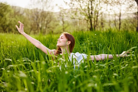 a woman rejoices in a summer day and raises her hands enthusiastically. High quality photo