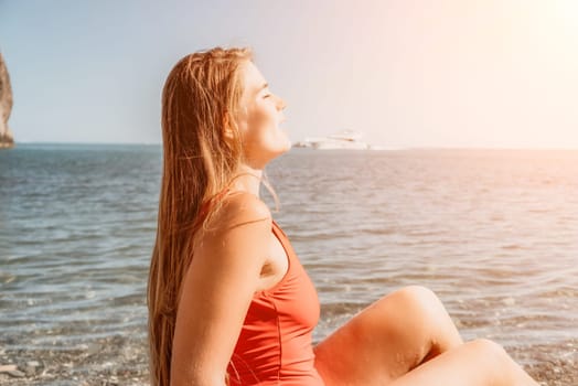 Sexy young woman in stylish bikini lying on seashore, closeup. Holiday, vacation and recreational concept.