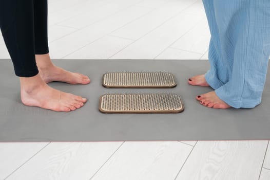 Female feet next to sadhu boards in yoga studio