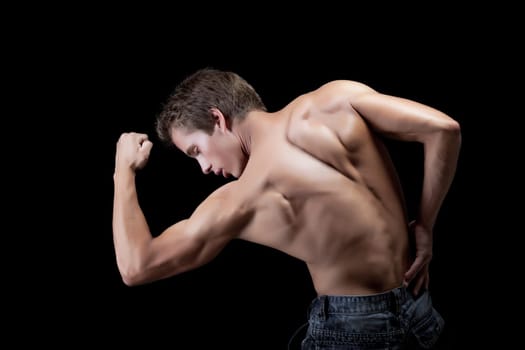 Image of handsome muscular man showing his biceps at camera