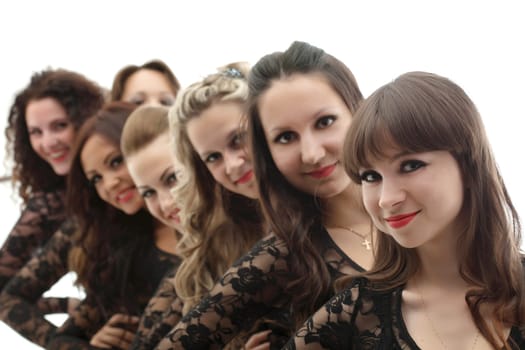 Group of young smiling girls posing in studio, close-up