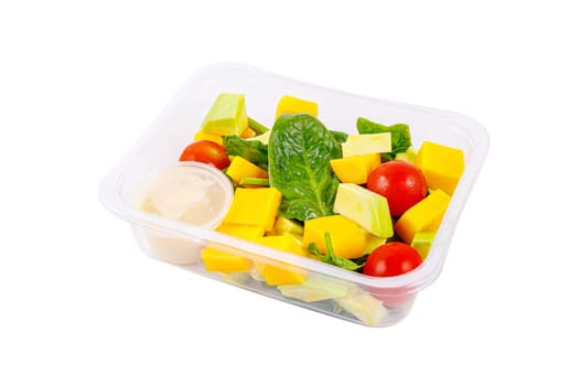 Fresh salad of avocado, mango, spinach and cherry tomatoes in a plastic container on a white background. High quality photo