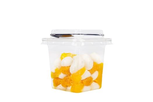 Dessert of cream, jam and orange in a plastic glass on a white background. High quality photo