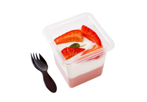Dessert of white and pink cream with strawberries in a plastic container on a white background. High quality photo