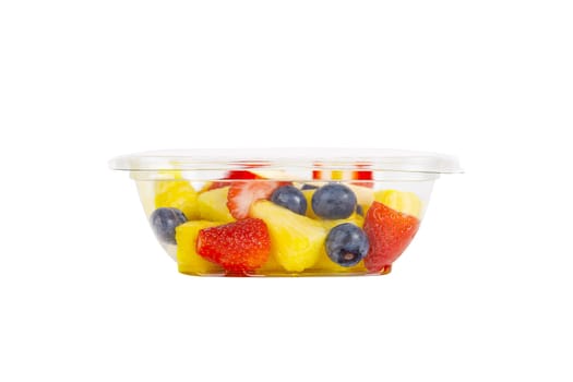Fruit salad with pineapple, strawberries and blueberries in a plastic container on a white background. High quality photo