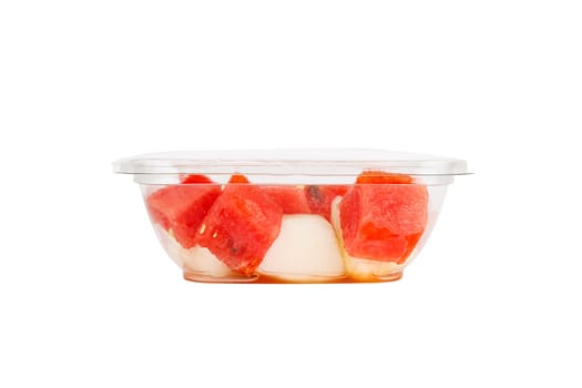Fruit salad with watermelon and melon in a plastic container on a white background. High quality photo