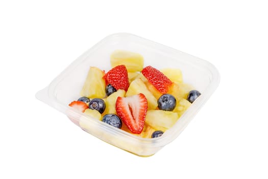 Fruit salad with pineapple, strawberries and blueberries in a plastic container on a white background. High quality photo