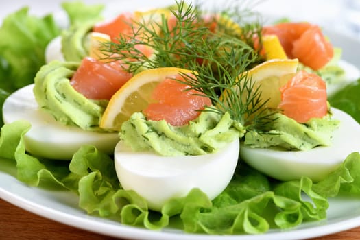 Eggs stuffed with avocado, salmon and lemon. The perfect appetizer for your holiday table.