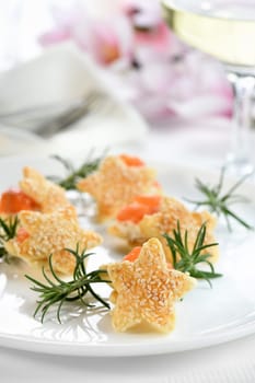 Festive appetizer of puff pastry in the shape of a star, stuffed with salmon and soft cheese. The perfect appetizer for your holiday table.