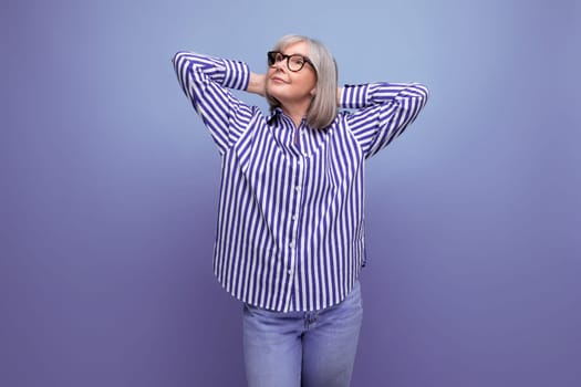 dreamy stylish mature old lady with gray hair on bright studio background with copy space.