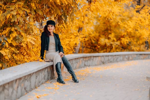 A woman walks outdoors in autumn, enjoys the autumn weather