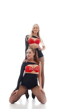 Smiling attractive go-go dancers isolated on white background