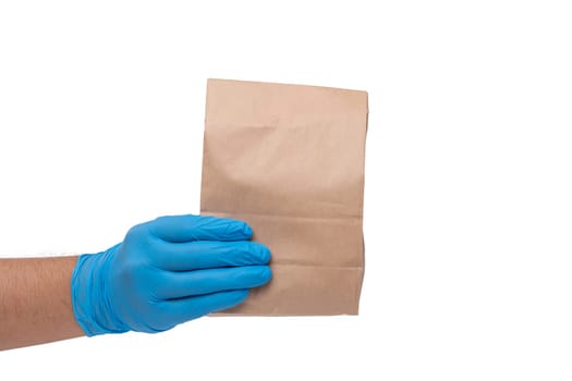 Close up hand in medical glove and holding food paper bag on white background ( Isolated background). Concept of Ordering food online and delivery service.