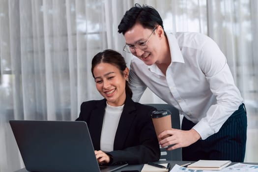 Mentor, manager with coffee advice younger colleagues in workplace. Couple businesspeople discussing financial strategy, working together for harmony and strong teamwork in office concept