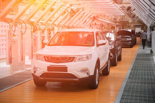 Photo of automobile production line. Modern car assembly plant. Modern and high-tech automotive industry. Conveyor of auto bodies