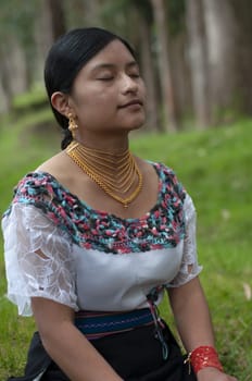 indigenous woman meditating in a sacred place in the jungle. High quality photo