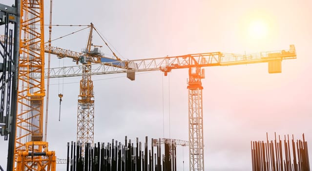 Construction of a nuclear power plant. Tower cranes on the background of the cooling tower.