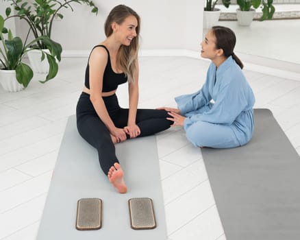 The therapist supports the client after standing on the sadhu boards. Nailing practice