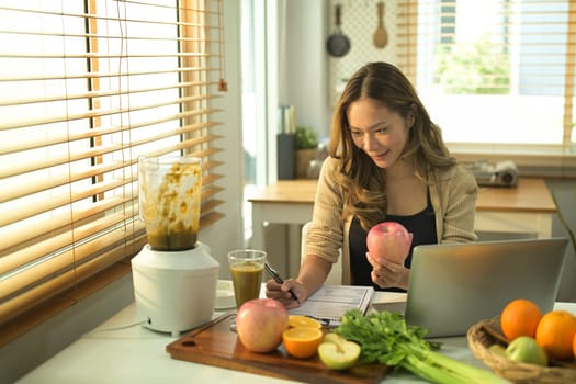 Nutritionist woman woking with fruits at her desk. High quality photo