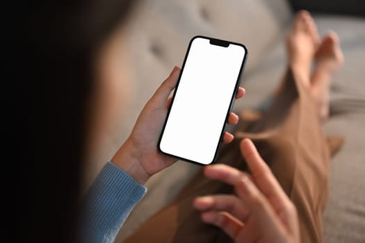 Woman using her smartphone with empty screen. High quality photo