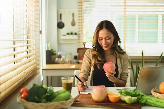 Nutritionist woman woking with fruits at her desk. High quality photo